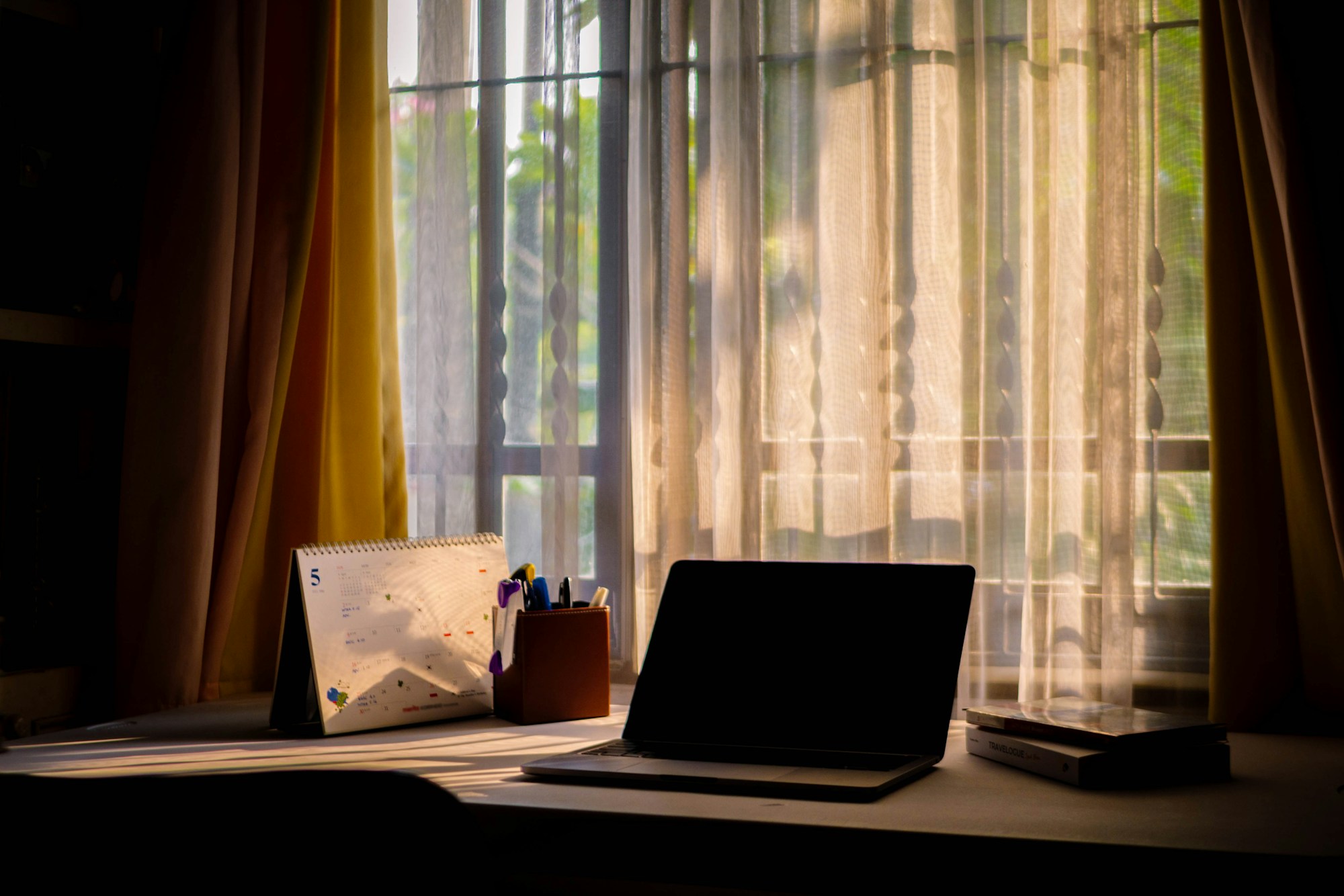 Laptop on a calm desk with warm daylight