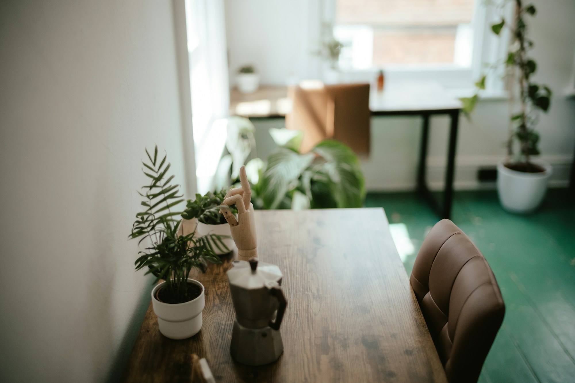 Wooden table surrounded by potted plants in a calm room