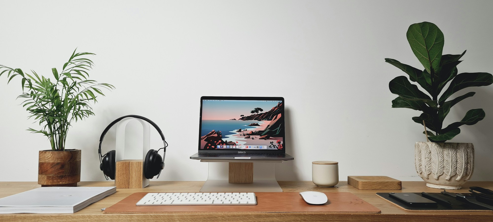 Tidy desk setup flanked by potted plants